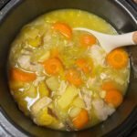 easy chicken soup in a pressure cooker. carrots, potatoes, and chicken float in a golden broth.