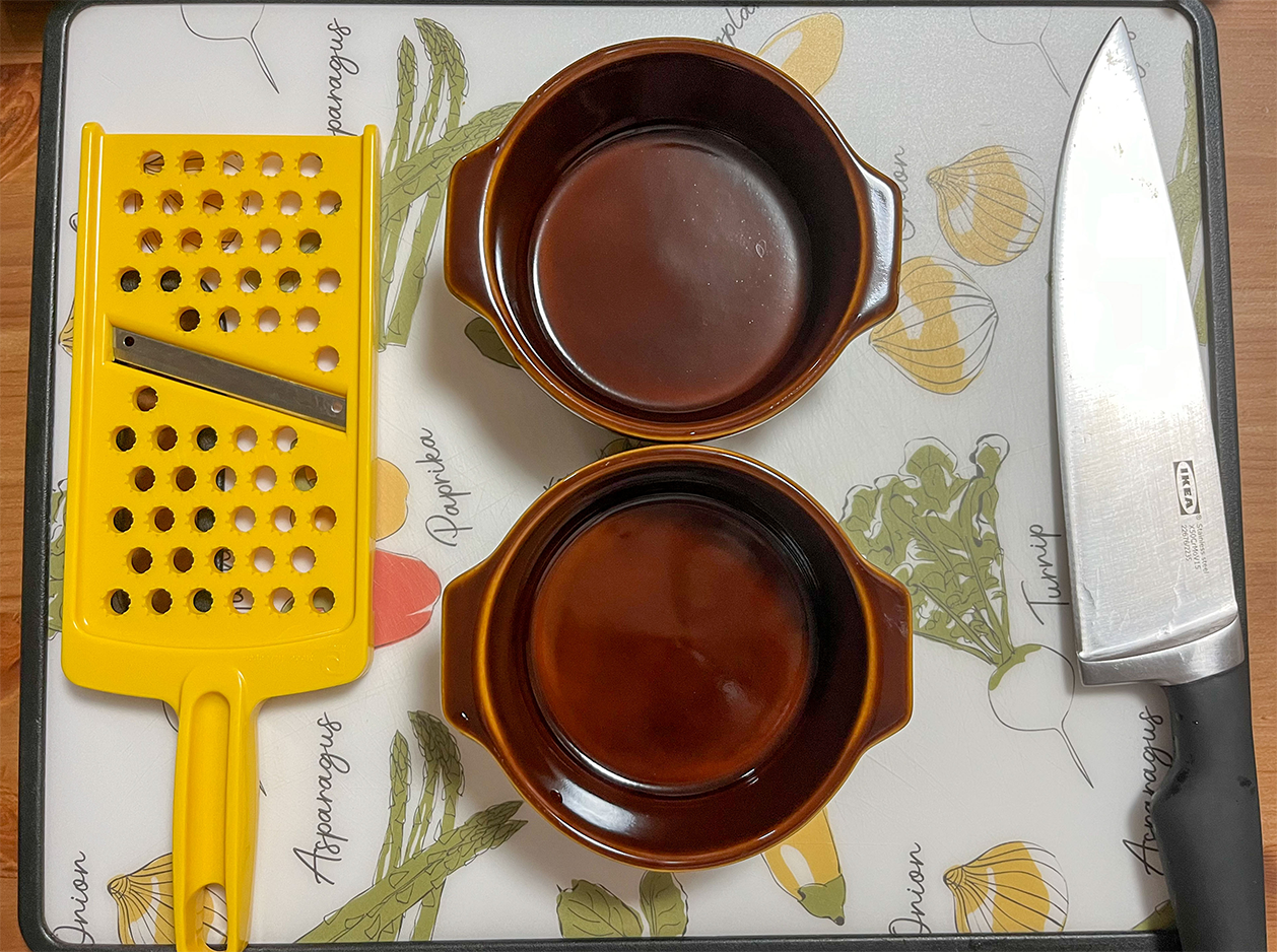 grater, ramekins, knife and cutting board